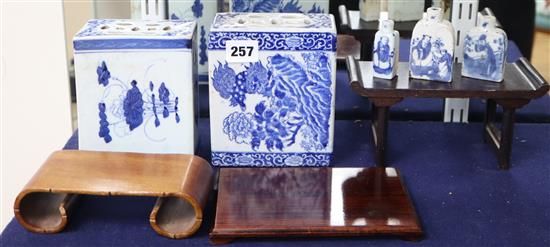 Two Chinese blue and white pillows and three similar snuff bottles, with three hardwood stands